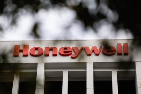 Red "Honeywell" sign on an Atlanta office building, framed by blurred tree branches