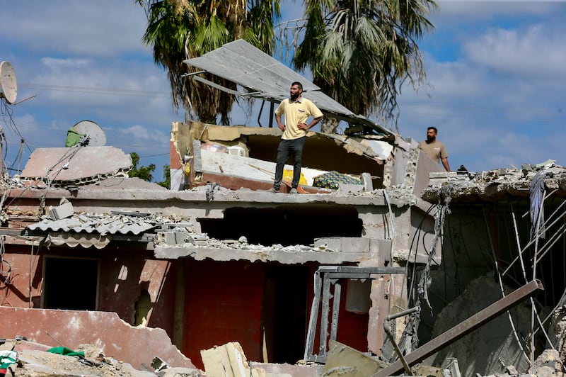 People inspect damage following an Israeli air strike in Lebanon's southern port city of Tyre. EPA