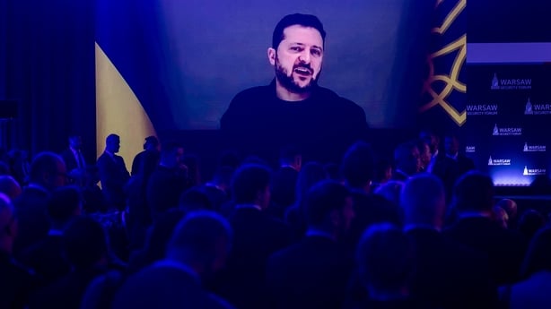 Participants listen as Ukraine's President Volodymyr Zelensky speaks via videolink during the opening session of the Warsaw Security Forum in Warsaw, Poland on October 12, 2026. (Photo by Wojtek RADWANSKI / AFP)