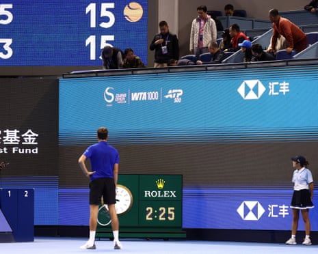 Daniil Medvedev stands on court as officials attend to an injured spectator