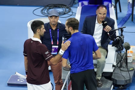 Daniil Medvedev (right) is patted on the shoulder by Novak Djokovic