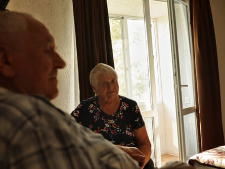 An older man and woman in a hotel room.
